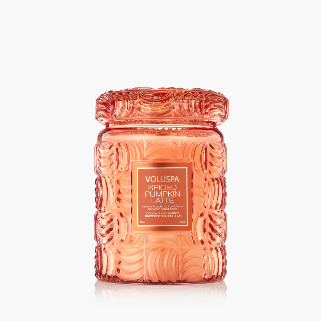 The Voluspa Spiced Pumpkin Latte Large Jar 18oz Candle features a textured orange design and coconut wax blend, displayed against a white background. The label reads "Voluspa Spiced Pumpkin Latte.