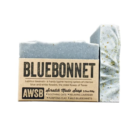 A Wild Soap Bars Bluebonnet soap features a blue hue, speckled texture, and is infused with lavandin essential oil, organic vegetable oils, soothing oats, relaxing lavender, purifying clay, and wild blueberries.