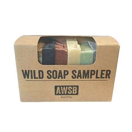 The A Wild Soap Bar - Sampler Gift Set by A Wild Soap Bar features five colorful natural handmade organic soap bars, visible through a clear window on the cardboard box labeled with AWSB. The total weight is 8oz (227g).