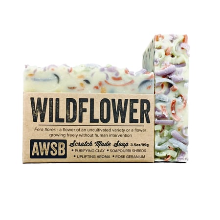 The A Wild Soap Bar - Wildflower by A Wild Soap Bar is crafted with purifying clay, soap curl shreds, and vibrant botanicals. It features an enchanting rose geranium scent and colorful curls elegantly embedded in a creamy base for a visually delightful cleanse.