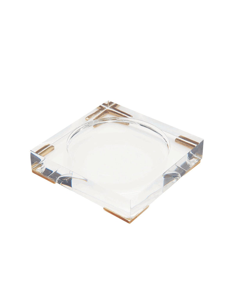 The clear square acrylic tray by Antica Farmacista, designed for a 250ml diffuser, features a circular center indentation and gold-toned corner accents, mirroring the elegance of their diffusers.