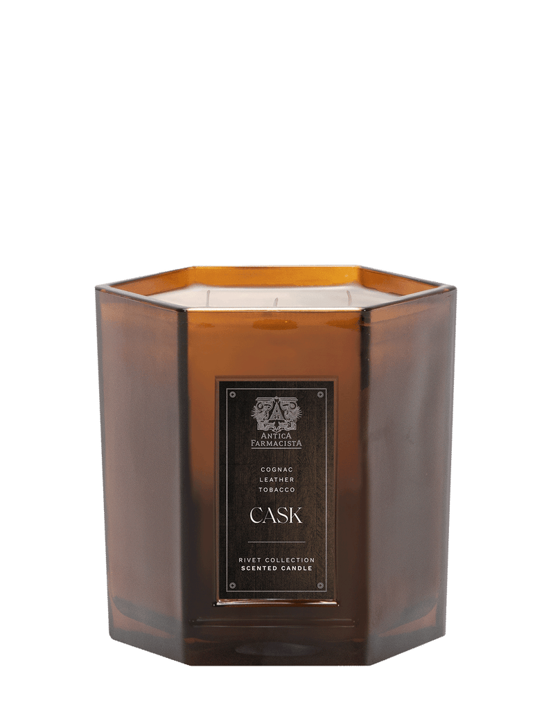 The Antica Farmacista - Cask 3 Wick 25oz Candle, a luxurious part of the Rivet Collection, boasts a hexagonal design and rich scents of cognac, leather, and tobacco for an exquisite fragrance experience.