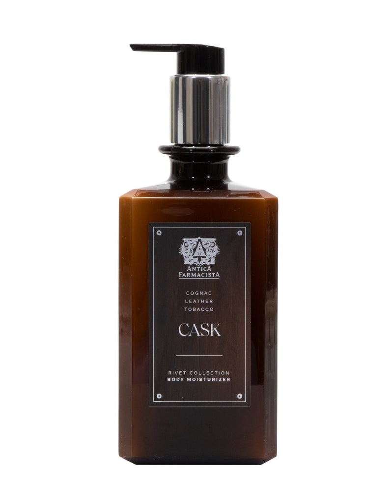 The Antica Farmacista Cask Body Moisturizer (16oz) comes in a brown bottle with a silver pump. It features shea butter and captivating scents of cognac, leather, and tobacco as part of the Rivet Collection.