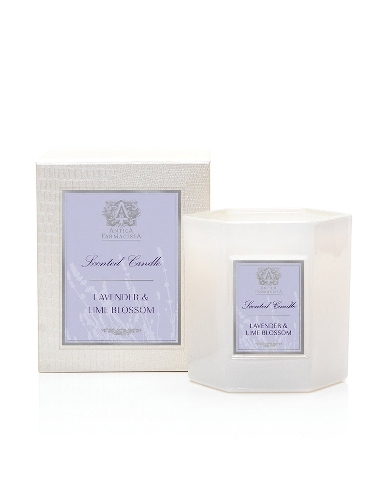 The Antica Farmacista - Lavender & Lime Blossom 9oz Candle, made from a soy-paraffin blend, sits in a hexagonal jar with elegant lavender and lime blossom labels. Its sophisticated packaging stands out against a plain white background.