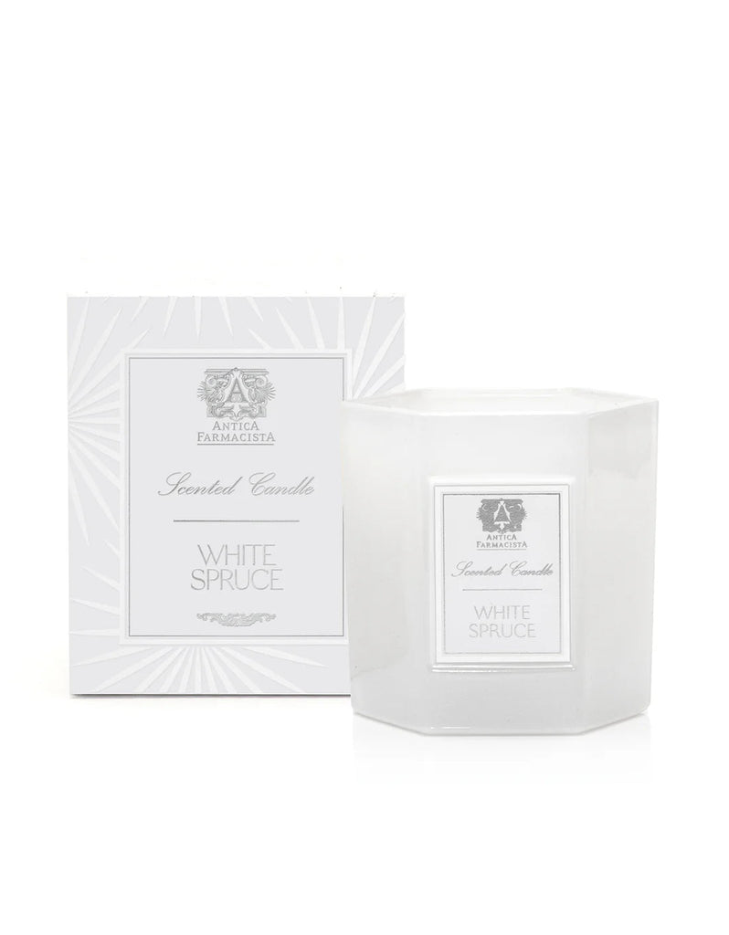 The Antica Farmacista White Spruce 9oz Candle, made from a soy-paraffin blend, is elegantly paired with its matching box. The subtle design showcases the evergreen scent and features the brand name Antica Farmacista in sleek gray text and accents.