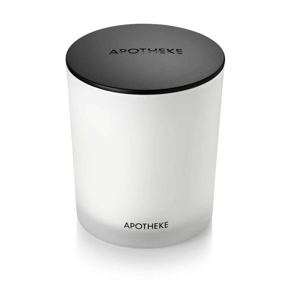 The Apotheke Black Classic Candle features a white scented candle with a matte black lid, showcasing the APOTHEKE label on both the lid and the jar, embodying timeless elegance.