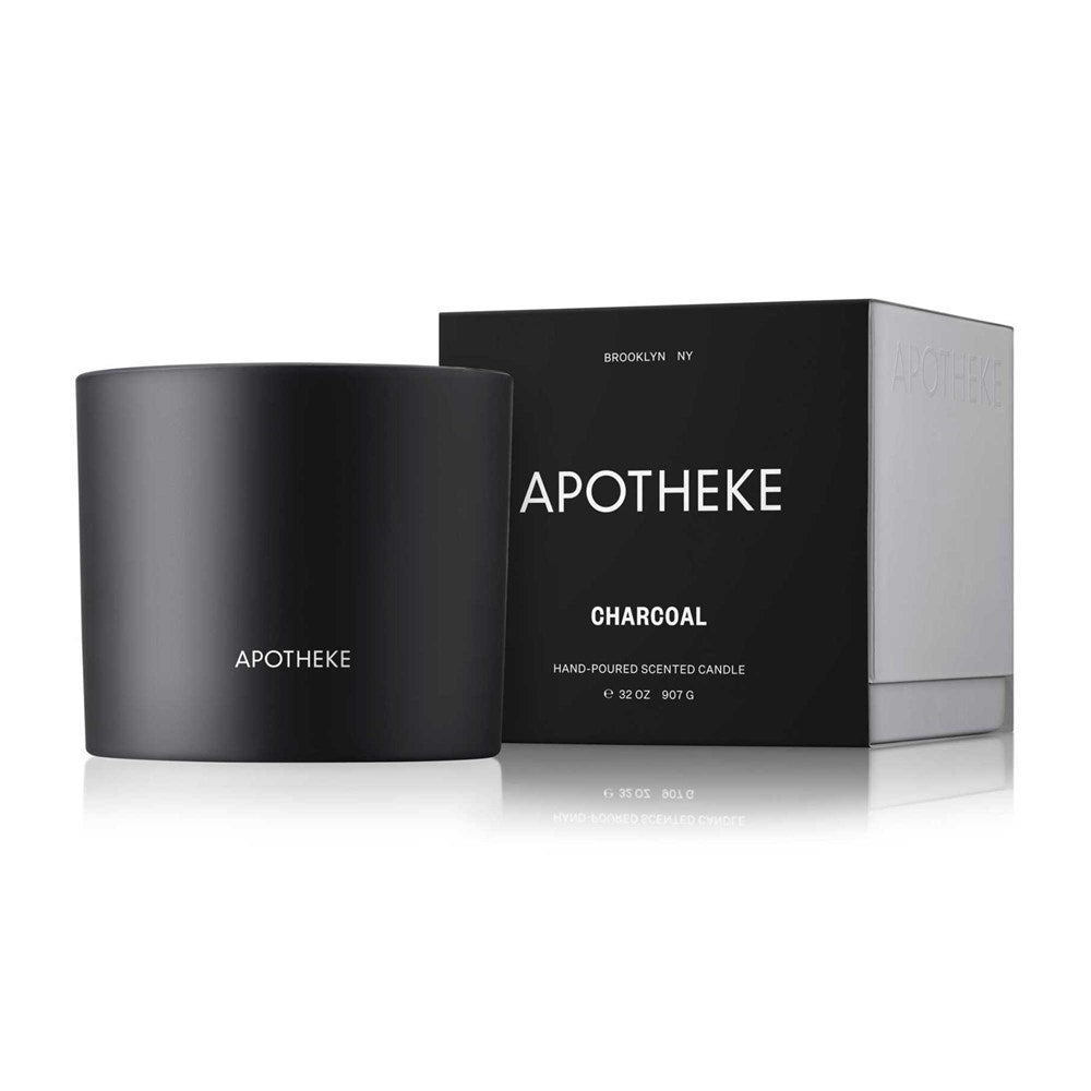 A photo captures the Apotheke Charcoal 3-Wick Candle, made with premium soy wax in a sleek black container featuring the Apotheke logo. Behind it is a matching black and gray box with white text displaying the brands name and details.