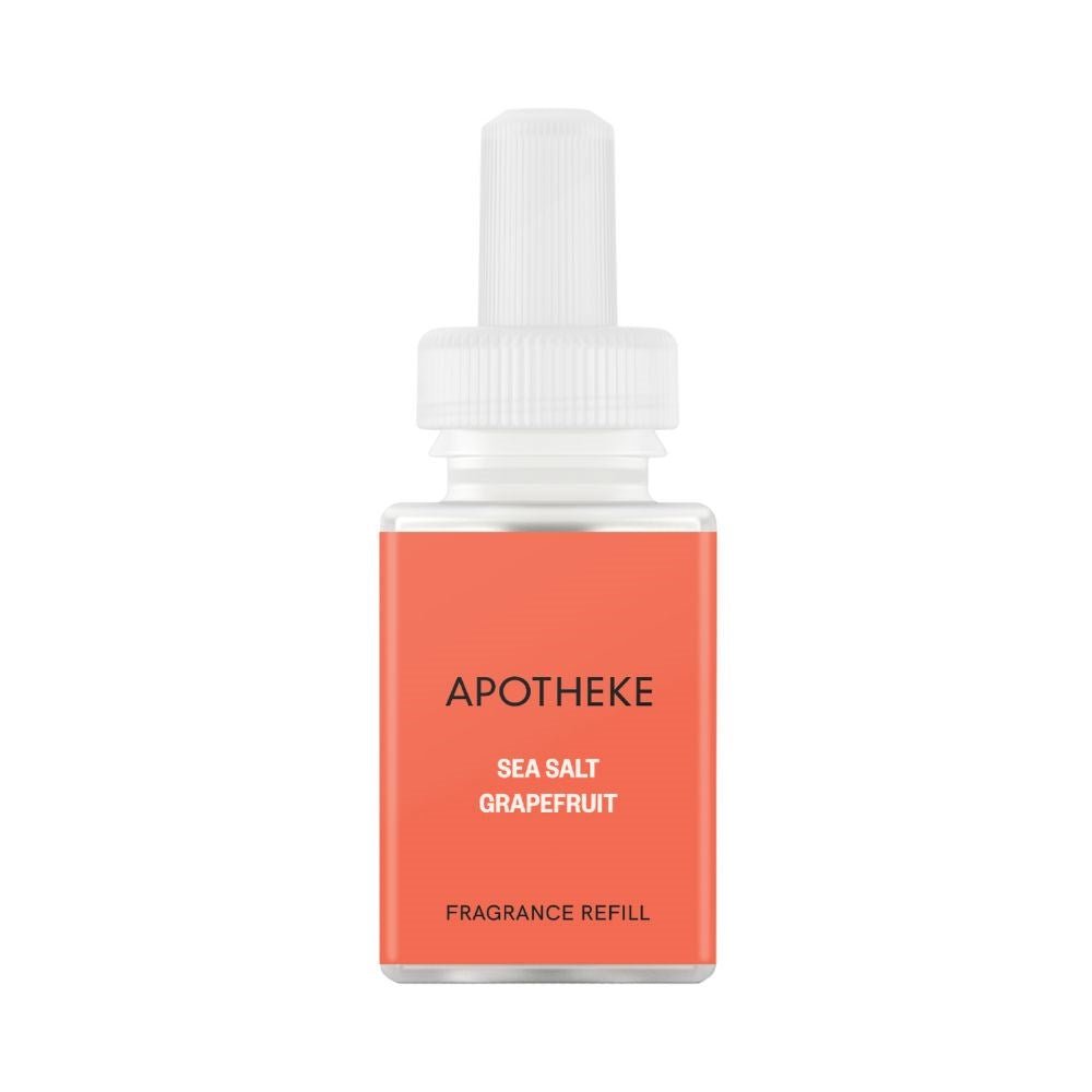 The Apotheke Sea Salt Grapefruit Refill, designed for the Pura Smart Home Diffuser, features an orange label with white and black text. It offers a refreshing scent experience with ethically sourced fragrances and comes with a white cap.