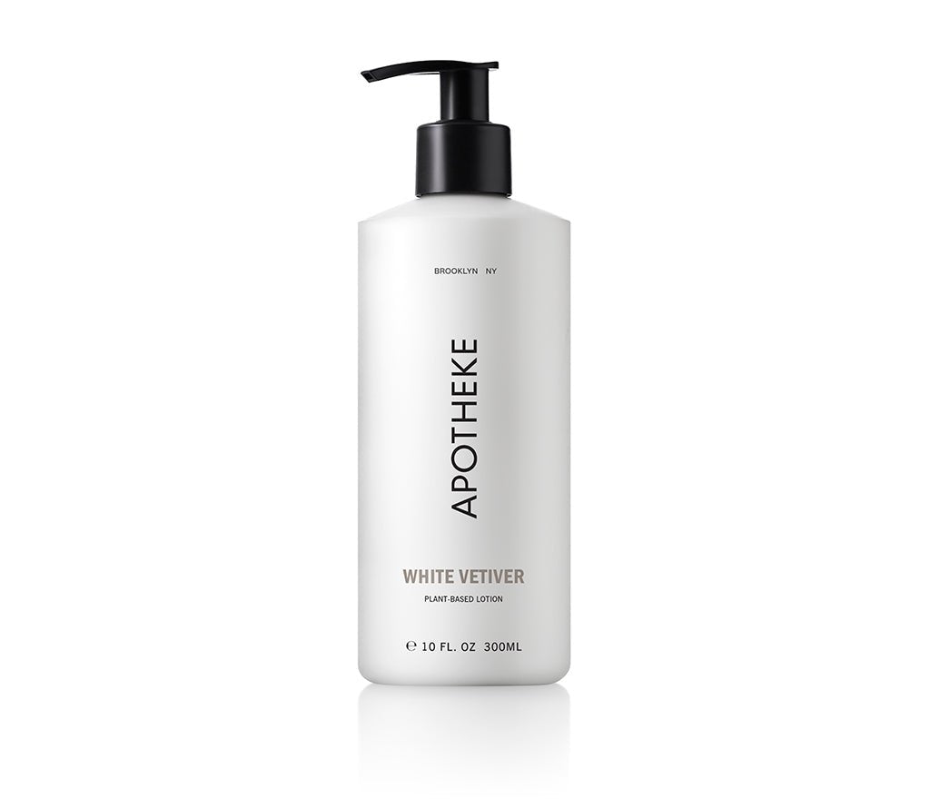 A 10 fl oz (300 ml) sleek white Apotheke - White Vetiver Lotion bottle with a black pump dispenser displays the label Apotheke, Brooklyn NY, White Vetiver, emphasizing its aloe-infused, plant-based ingredients.