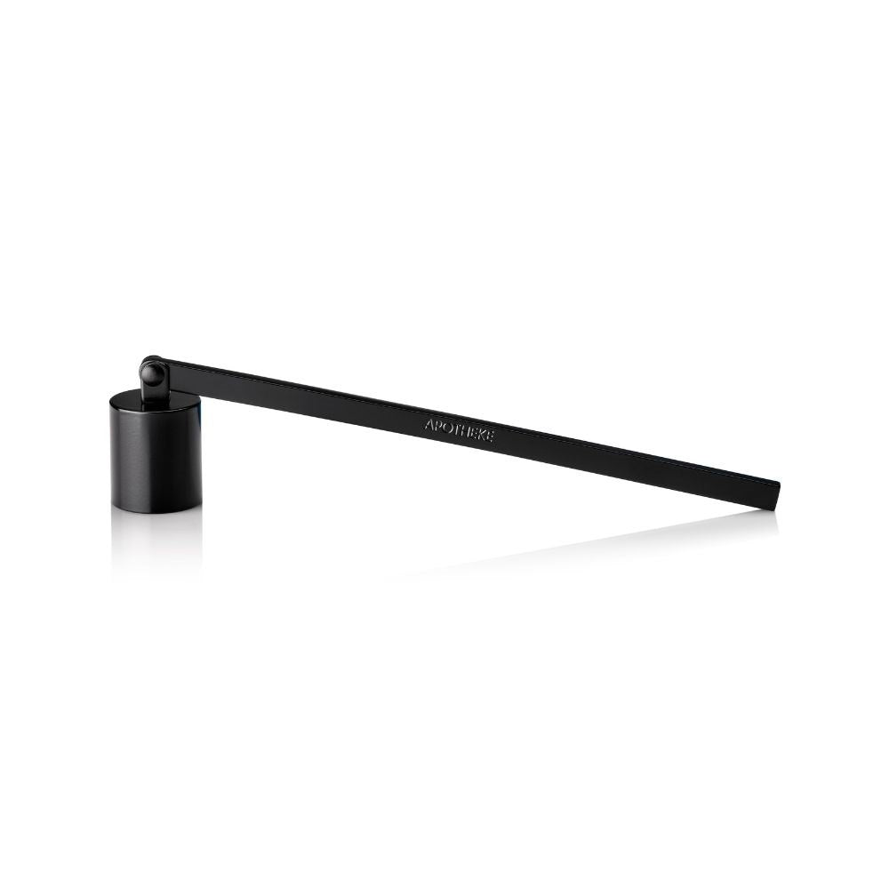 The Apotheke Wick Snuffer Black features a long, sleek matte handle with an embossed logo and a small cylindrical cup, designed for safely extinguishing candle flames without blowing. This elegant accessory by Apotheke stands out against the plain white background.