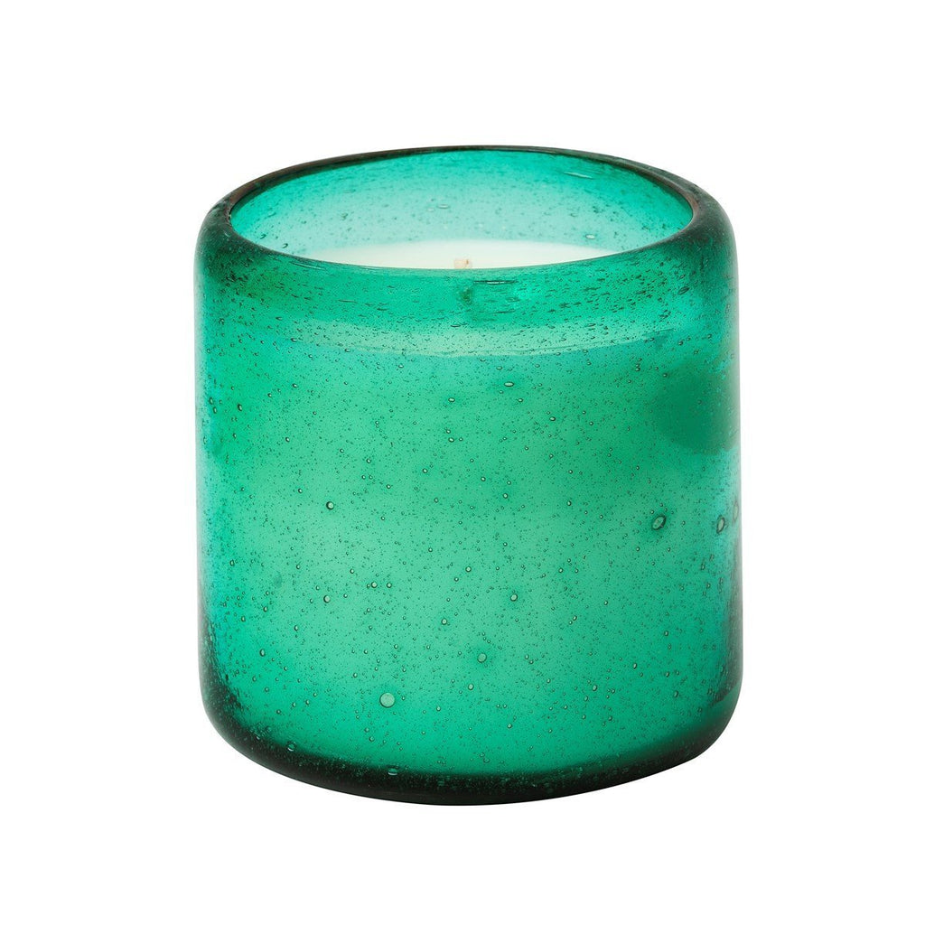 The Aqua De Soi - Melon Mojito 8oz Effervescent Candle features a green glass holder with a smooth, rounded shape and speckled texture. Its slight translucency allows the white candle inside to create a glowing effect, exuding a fresh mint ambiance.