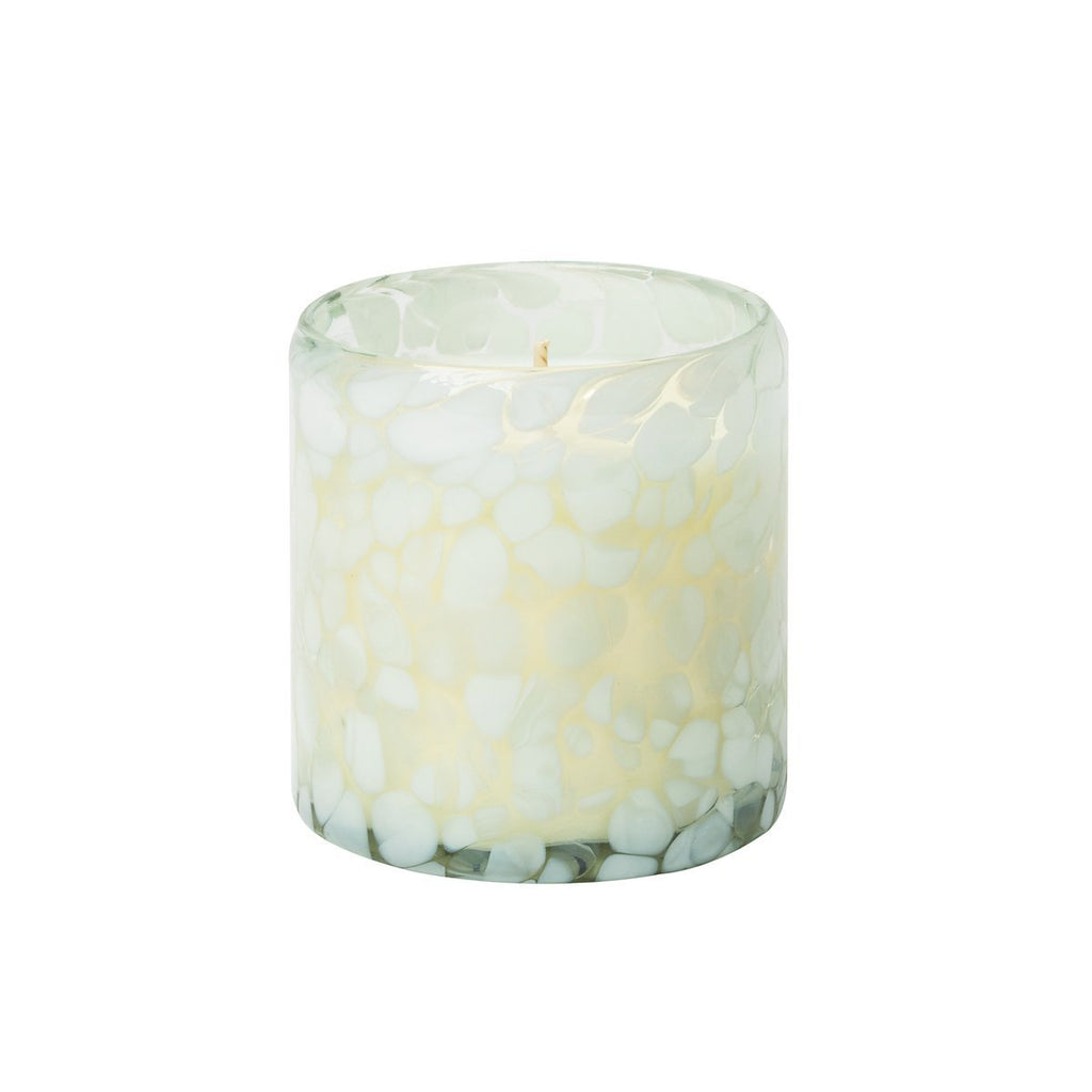 The Aqua De Soi - Vanilla Sands 8oz Confetti Candle, by Aqua De Soi, is a decorative artisan candle in a hand-blown glass container featuring a marbled white and light green pattern, elegantly infused with Warm Vanilla Sugar.