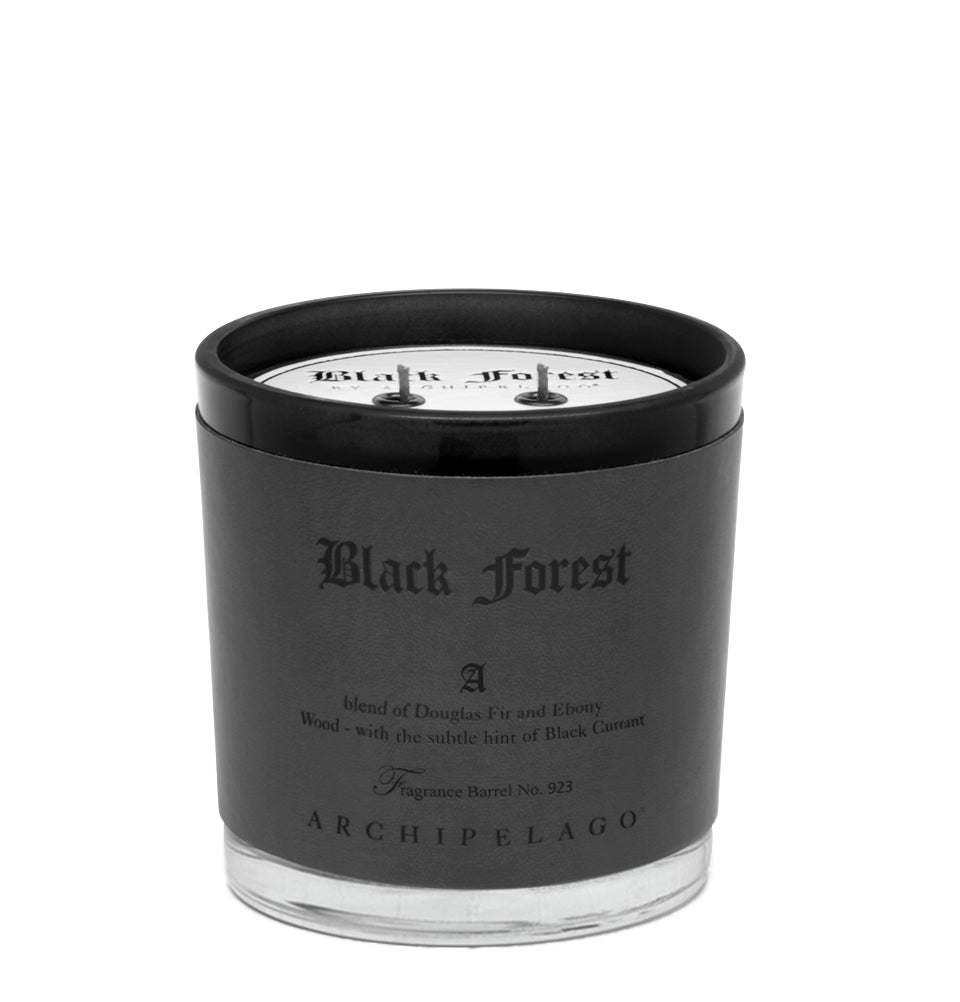 The Archipelago - Black Forest Letter Press 13oz Candle features ebony woods, Douglas fir, and black currant. Its sleek black and silver glass container with two wicks adds elegance and depth to any space.
