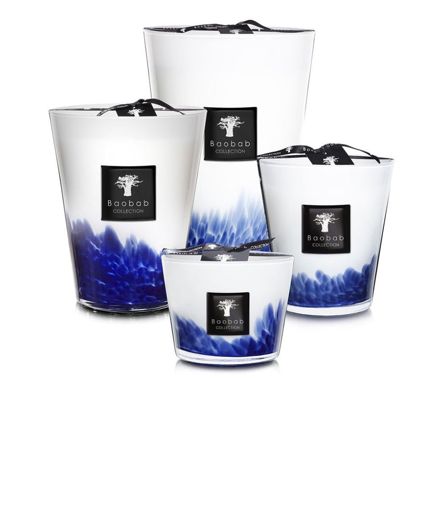 Four Baobab candles from the Feathers Touareg collection feature white wax with blue accents and have a Sahara scent. Each is presented in a clear glass jar with Touareg designs, adorned with a black label showcasing the Baobab tree logo.