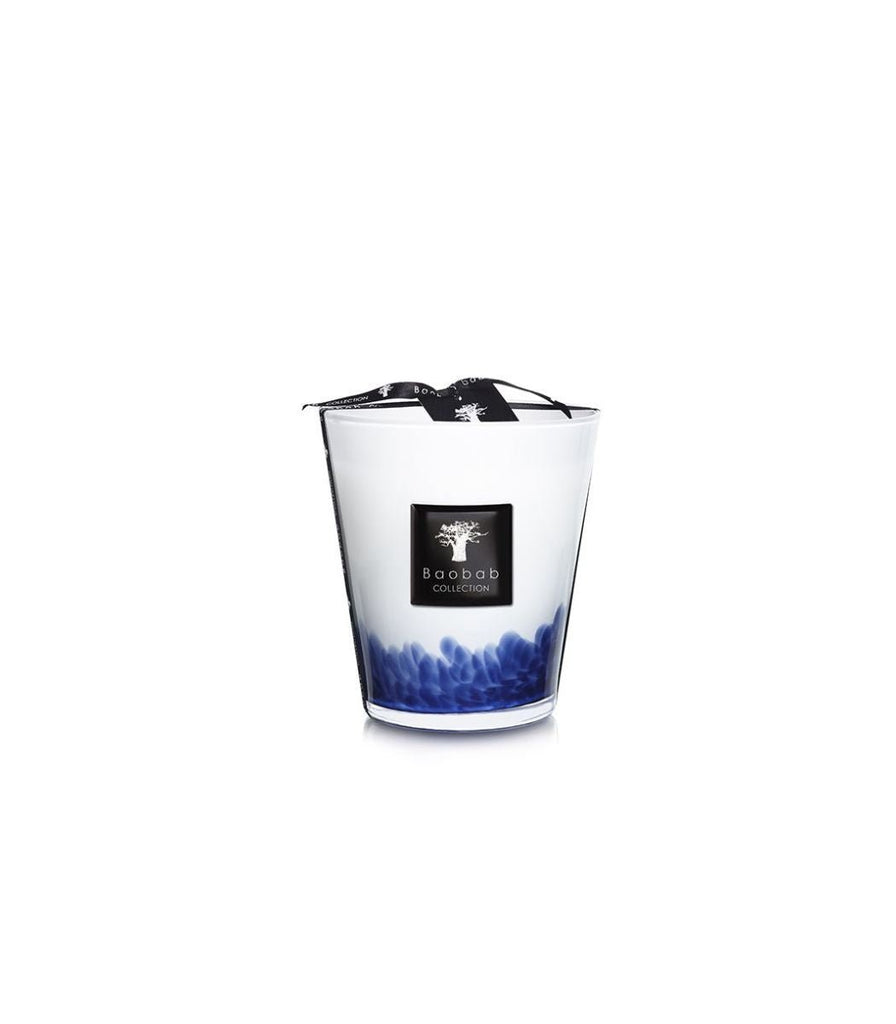 A white scented candle from Boabab - Feathers Touareg Max 16 by Baobab is in a glass container with blue accents at the base. A black label reads Baobab Collection, and a black ribbon with white text adorns the top, evoking an aromatic fragrance against a plain white background.