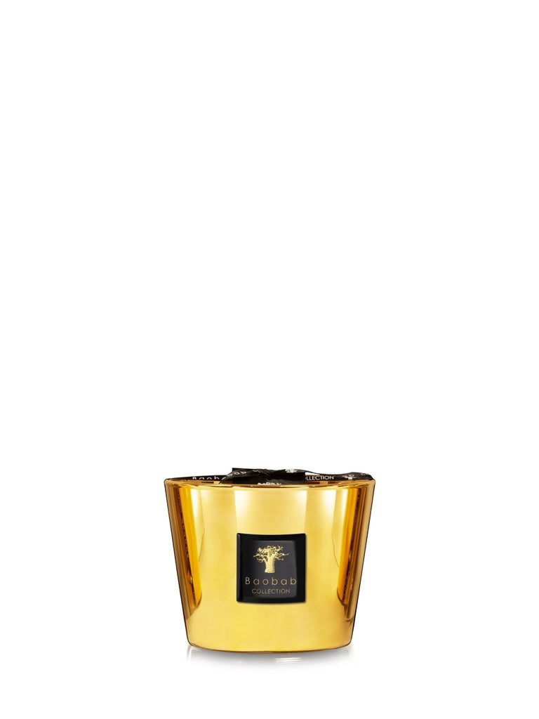 A large, luxurious gold candle labeled Baobab Collection with a glossy finish reflects light elegantly. This unlit Baobab - Les Exclusives Aurum Max 10 Candle hints at a soothing jasmine musk aroma ready to envelop any space.