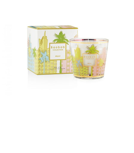 The 6.7oz My First Baobab Miami candle by Baobab showcases a fresh scent and vibrant design featuring a colorful cityscape and palm trees, paired with a matching box. Both items highlight the iconic art deco vibe Miami is known for.