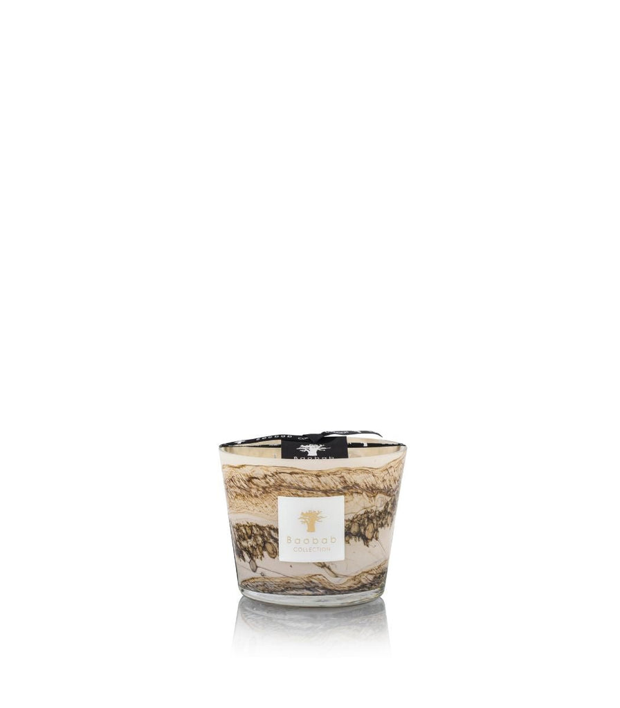 The Boabab - Sands - Siloli Max 10 Candle by Baobab exudes cedarwood fragrance in a mouth-blown glass holder with a beige and brown marbled design. A black ribbon adorns the top, and its label features an elegant logo and text on a plain white background.