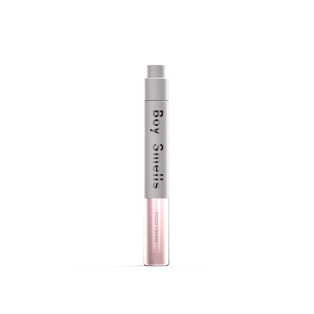 The Boy Smells - Coco Cream Eau de Parfum 10ml features a slim bottle with a silver-gray top and light pink base, set against a white background—evoking notes of vanilla and creamy coconut milk.