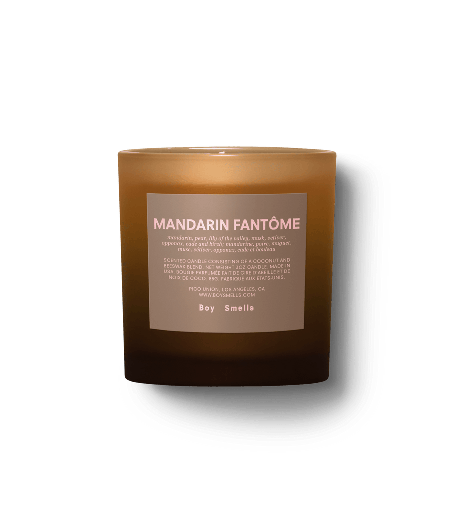 The Boy Smells - Mandarin Fantôme candle, in a brown glass, offers earthy woody aromas of mandarin and petit grain with smoked mandarin peel accents. The Boy Smells label contrasts against a simple black backdrop.