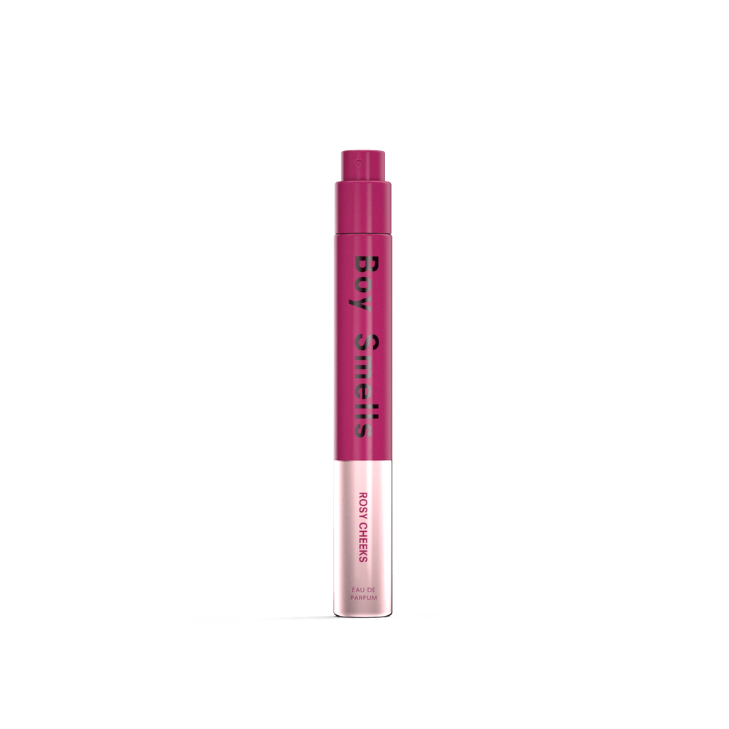 A pink and white cylindrical Boy Smells - Rosy Cheeks Eau de Parfum 10mle stands upright on a white background, suggesting a fruity-floral scent with pomegranate notes.
