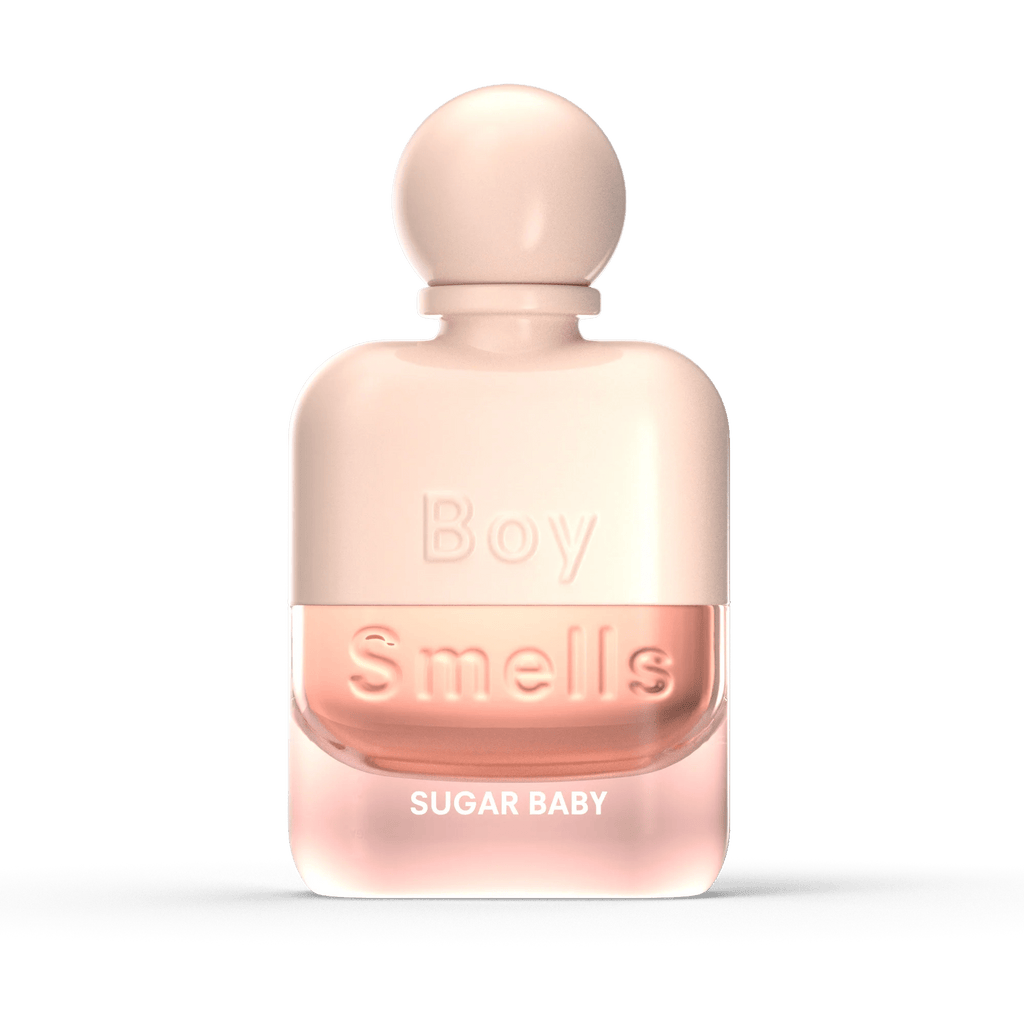 A frosted pink glass bottle of Boy Smells - Sugar Baby Eau de Parfum 50ml, with a round cap and light pink liquid, stands against a black background, exuding a sweet floral scent.