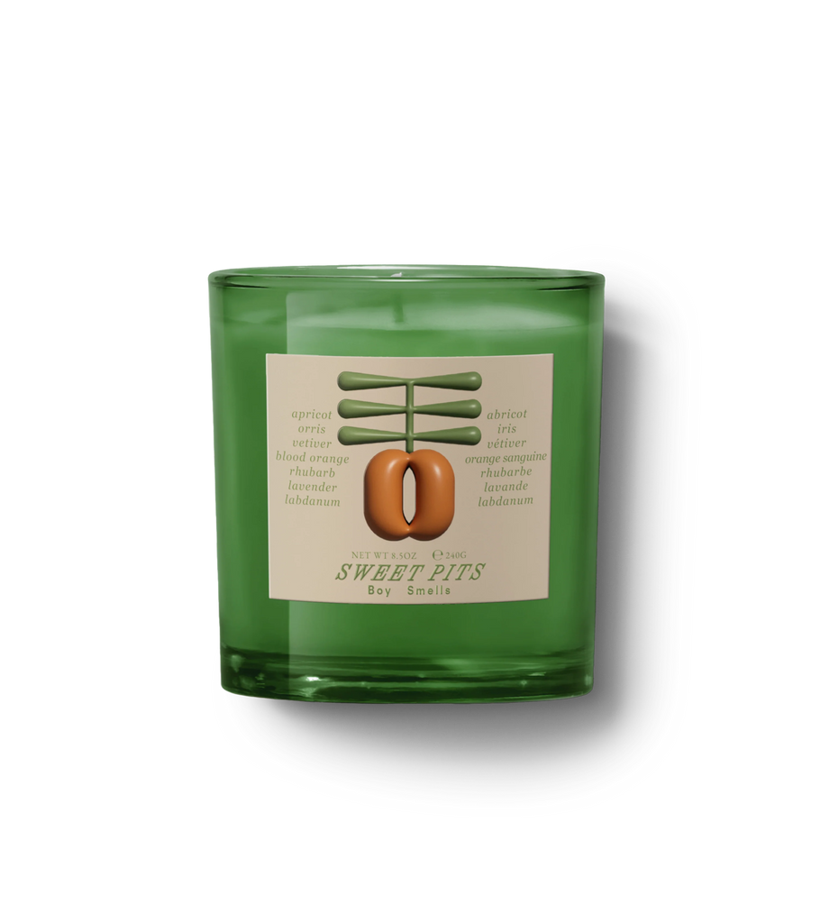 The Boy Smells - Sweet Pits 8.5oz candle in a glass jar features a stylish label and offers a sophisticated scent with notes of apricot, orange, and vetiver, hinting at its fruity gourmand essence.