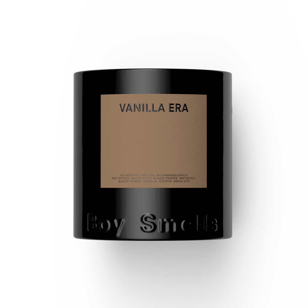 The Boy Smells - Vanilla Era 27oz Candle features a black jar with a tan label reading VANILLA ERA. "Boy Smells" is embossed at the bottom. Enjoy its gourmand scent, beautifully presented against a plain white background.