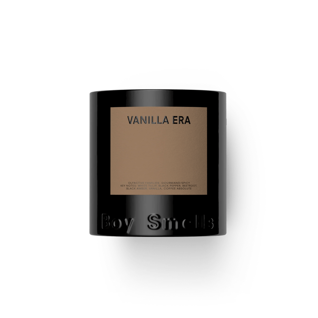 A black 8.5oz candle jar labeled Vanilla Era with a tan rectangular label from Boy Smells, embossed at the base, offers a gourmand scent blending rich vanilla notes.
