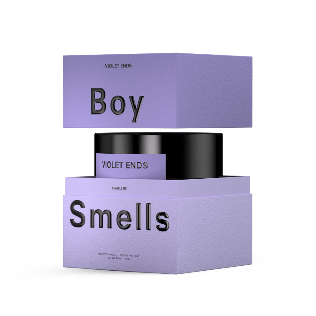 A purple box with black text displays “Boy Smells” and “Violet Ends.” The open box reveals a Boy Smells - Violet Ends 27oz Candle in a black violet container against a plain white background.