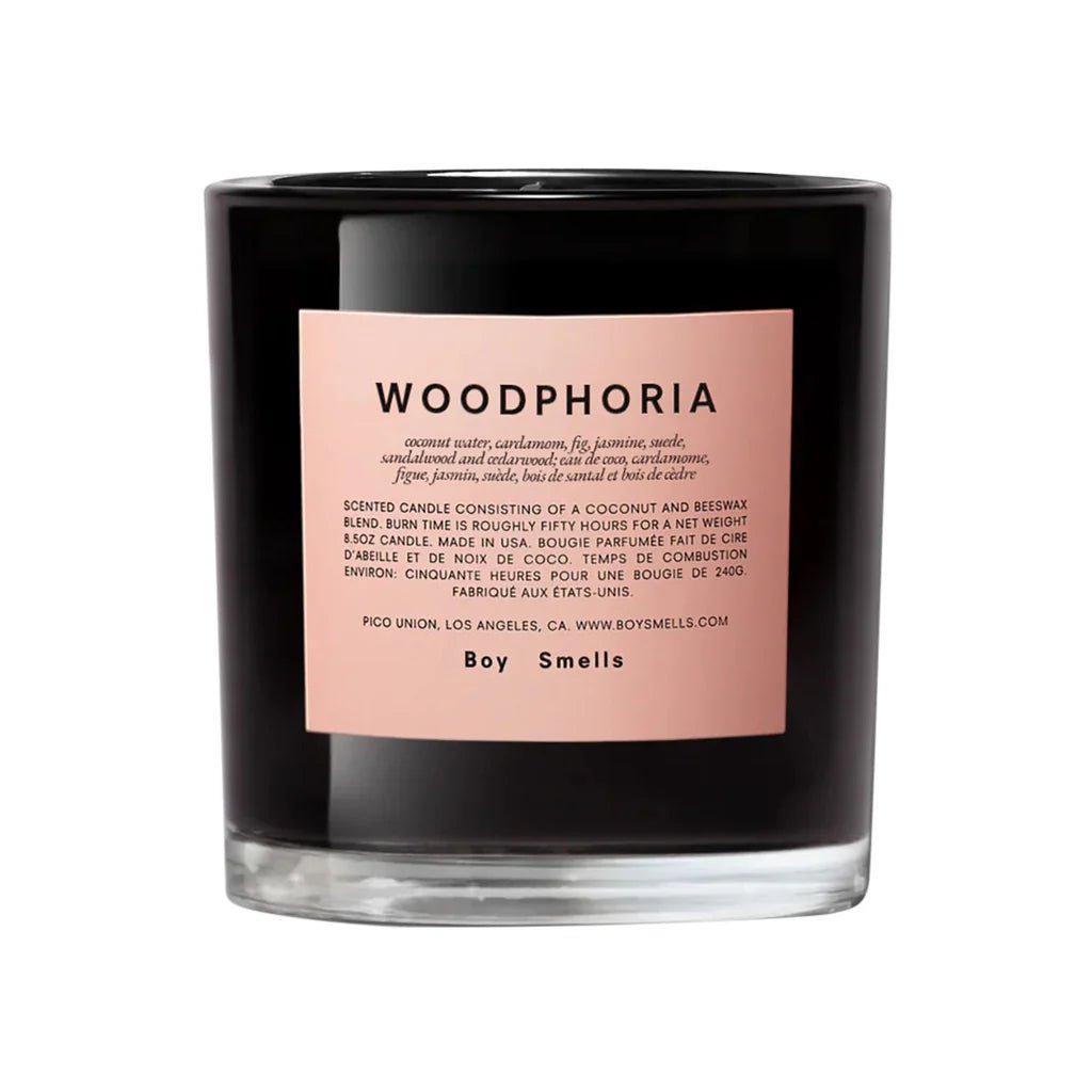 The Boy Smells - Woodphoria 8.5oz Candle features a black glass jar with a pale pink label reading WOODPHORIA, highlighting scent notes like sandalwood and coconut water, and displays the Boy Smells brand at the bottom.