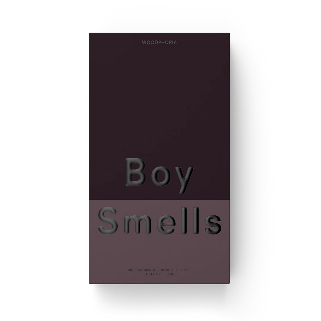 A rectangular, two-toned box for Boy Smells - Woodphoria Eau de Parfum 50ml features WOOPHORIA at the top and embossed Boy Smells text center, with colors fading from dark plum to mauve evoking sandalwood and fig leaves.