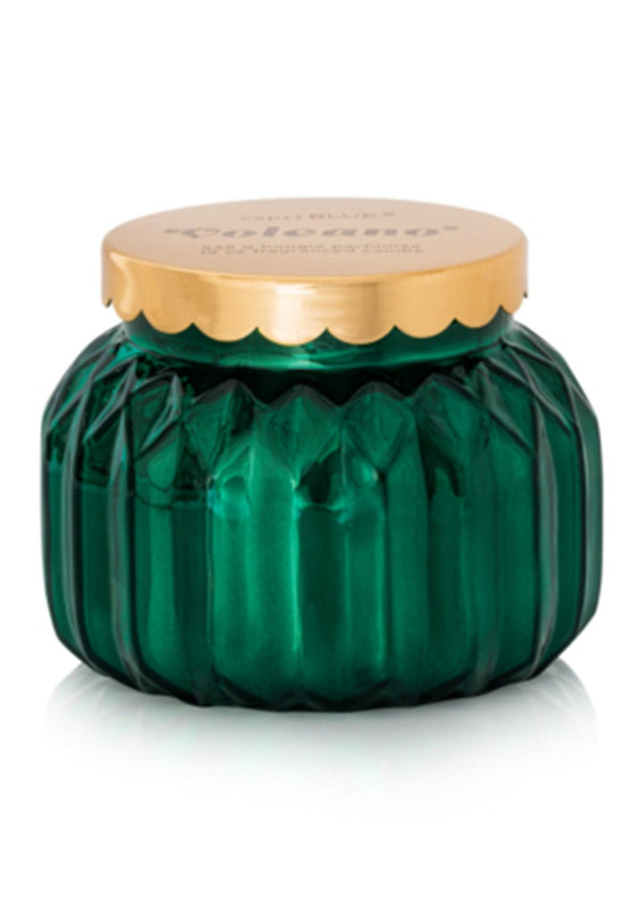 The Capri BLUE - Volcano Royal Gem Signature Candle, 19oz, features a green ribbed glass jar with a gold lid and textured sides, adding decorative elegance and the iconic Volcano fragrance to any space.