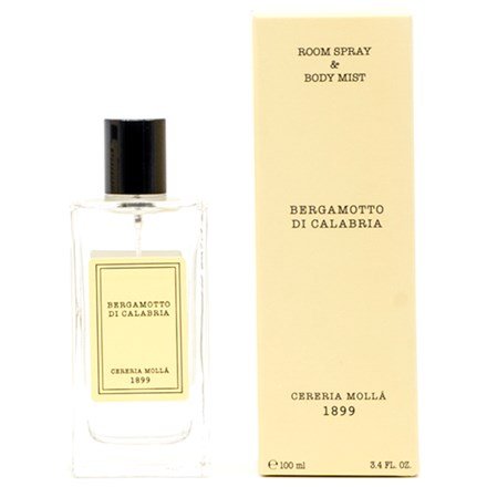 The Cereria Molla - Bergamotto Di Calabria 3.4oz Room Spray & Body Mist offers a refreshing Mediterranean scent. The clear bottle has a black cap and beige label, complemented by its tall beige box with elegant text.