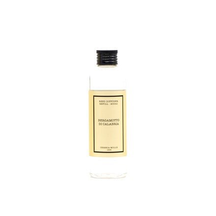 The Cereria Molla - Bergamotto Di Calabria 6.7oz Diffuser Refill, in a clear bottle with black cap, features Antica Farmacista and Reed Diffuser on a beige label with black text, evoking Mediterranean scents. The 250 ml bottle rests elegantly against a white background.