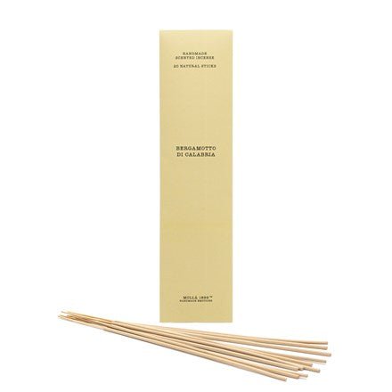 A yellow Cereria Molla box labeled Bergamotto di Calabria holds 20 incense sticks, exuding a Mediterranean breeze. The box has small text on the top and bottom describing the product, set against a white background.