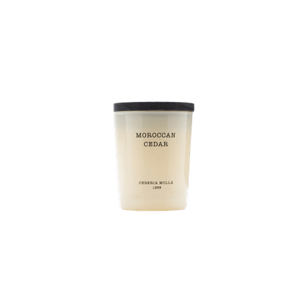 Enjoy the aroma of Moroccan Cedar with the Cereria Molla 2.6oz Candle, made from soy wax for a cleaner burn. Encased in frosted glass with a black lid, it features the CERERIA MOLLÀ 1899 inscription—a minimalist delight against a plain white backdrop.