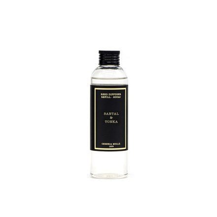 The Cereria Molla - Santal & Tonka 6.7oz Diffuser Refill is in a clear bottle with a black label and twist cap, featuring cedar oil and ORMAA NILLA 1939 text at the bottom, offering a premium scent for your space.