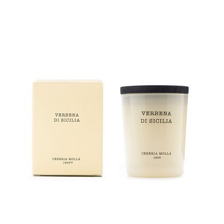 The cream-colored Cereria Molla - Verbena De Sicilia 2.6oz scented soy wax candle, with Verbena di Sicilia in black text, comes with a matching box and black lid. Both feature the Cereria Molla branding, offering simple and elegant packaging that captures timeless charm.