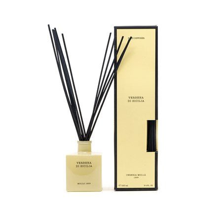 A cream-toned square diffuser bottle with black reeds, labeled Cereria Molla - Verbena Di Sicilia 3.4oz Reed Diffuser, evokes the fresh Sicilian coast scent. It stands elegantly beside its matching tall, rectangular box against a plain white background.