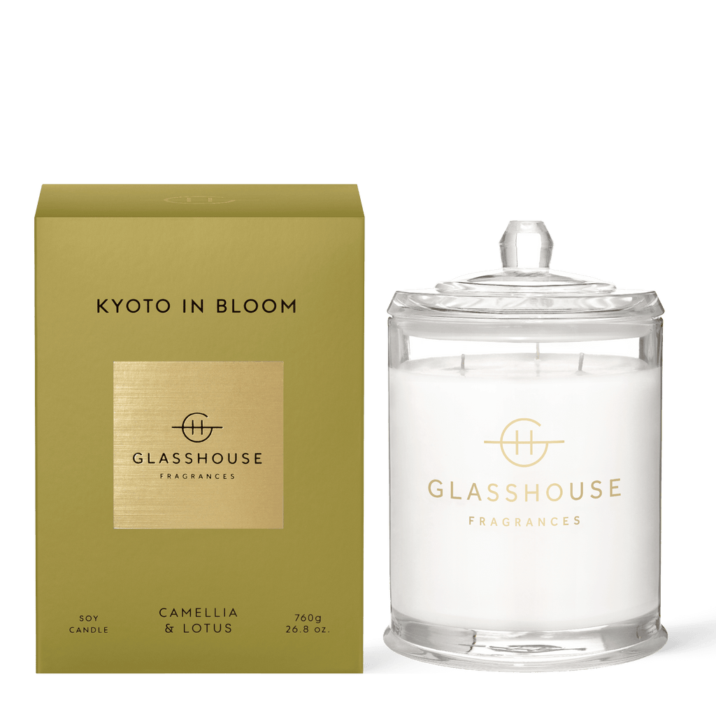 The 760g Kyoto in Bloom Candle by Glasshouse Fragrances features a triple-scented blend of camellia and lotus. Made from natural soy wax, it comes in a clear glass jar with a lid, elegantly paired with a matching green and gold box.