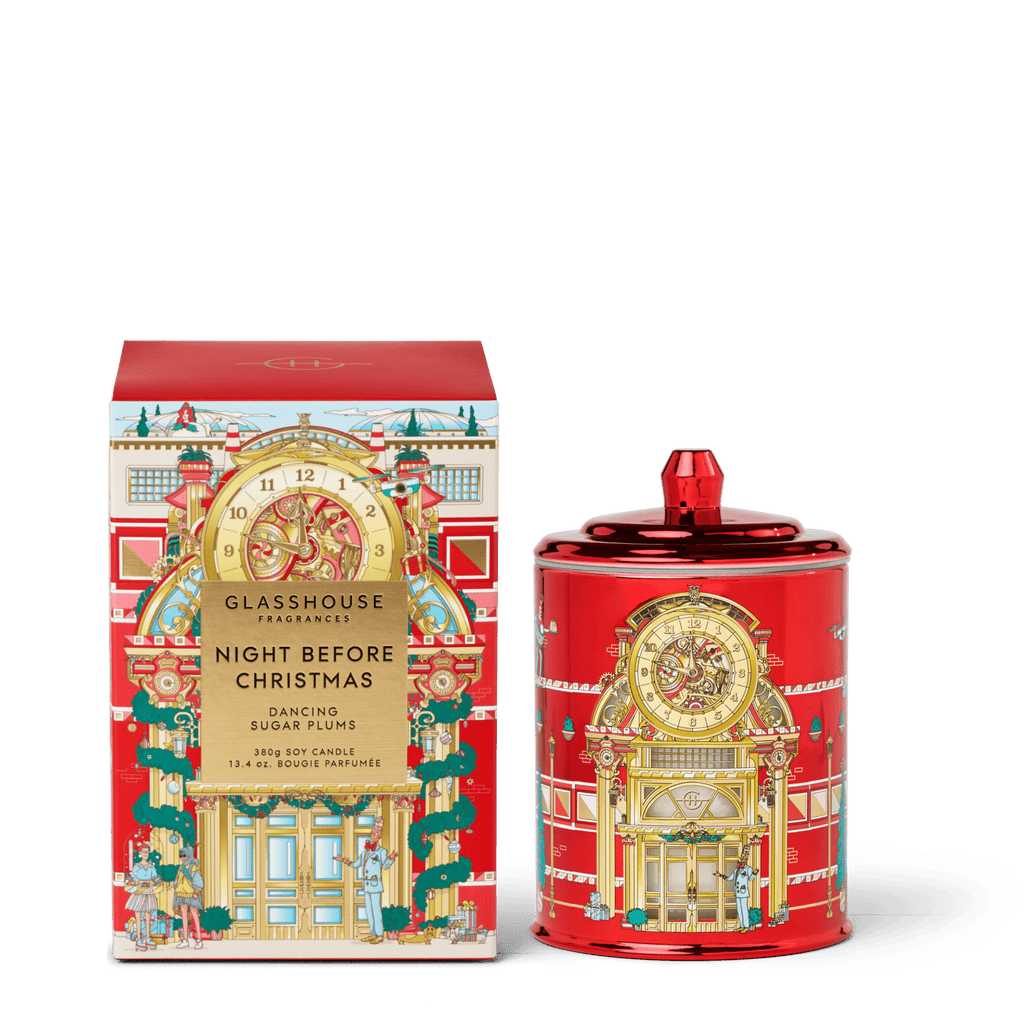 The Glasshouse Fragrances Night Before Christmas 13.4oz Candle comes in a festive red jar and box with gold holiday designs and a floral fragrance, perfect for the season.