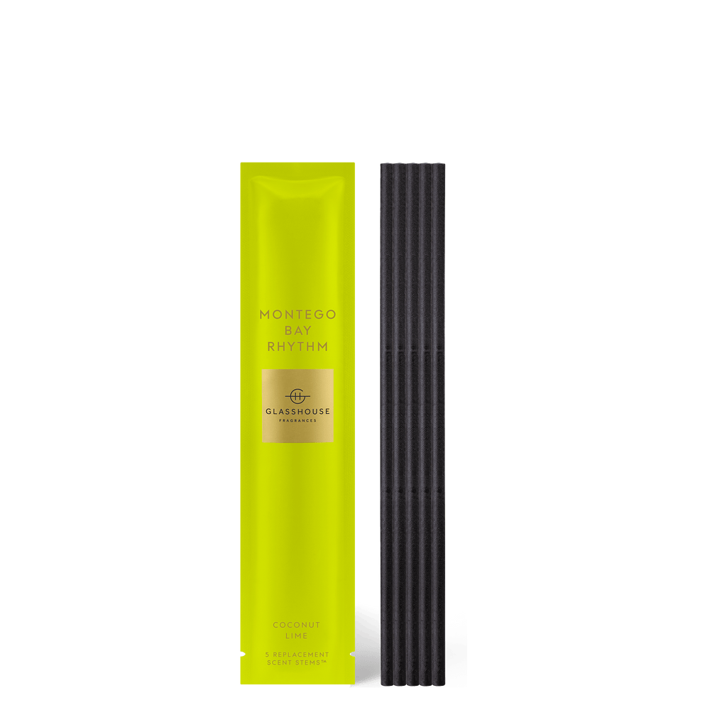 A bright yellow package for Glasshouse Fragrances Montego Bay Rhythm scent stems is shown with black stems. The label highlights the aromatic Coconut & Lime, ideal as home fragrance refills.