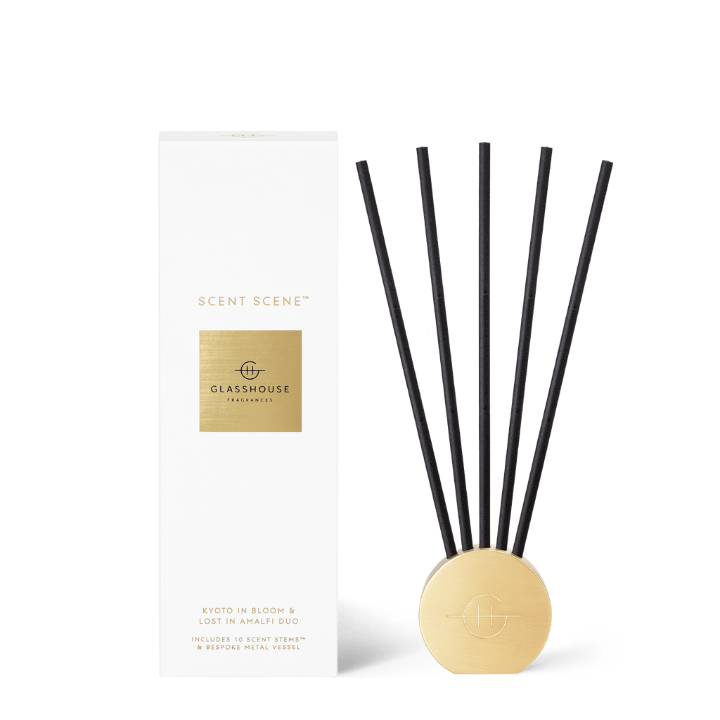 The Glasshouse Fragrances Scent Scene Duo Lost In Amafali & Kyoto In Bloom diffuser set includes a gold base and black reeds, featuring a minimalist design for an elegant display without liquid.