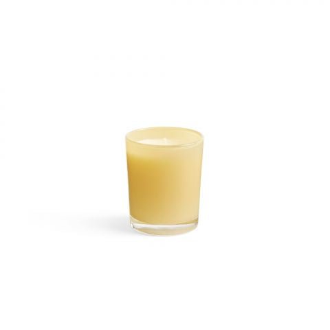 A Lafco - Chamomile Lavender 1.9oz Votive Candle, small and beige in a transparent glass, is centered on a plain white background with smooth, unlit wax casting a subtle shadow.