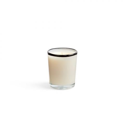 The Lafco Champagne 1.9oz Votive Candle features a subtle flame in a small clear glass holder, crafted from white soy wax. Its smooth design casts a gentle glow with exquisite hints of champagne ginger.