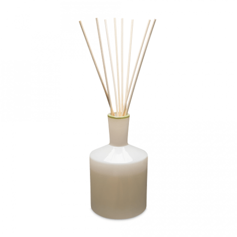 The Lafco - Feu de Bois 6oz Reed Diffuser features a sleek white-to-tan ceramic bottle and several wooden reeds to fill your space with calming sandalwood aroma. Perfect for adding elegance and soothing scents from the Lafco brand.