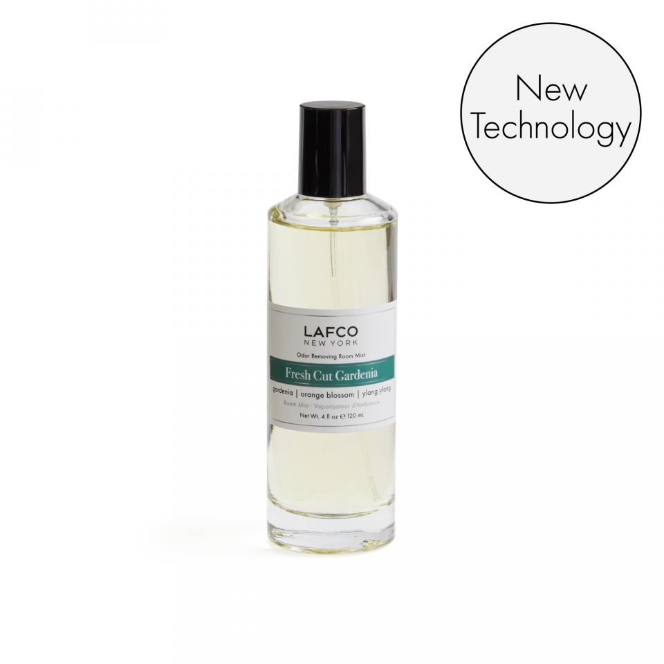 A clear bottle of Lafco - Fresh Cut Gardenia Room Mist with a silver cap and white label with green text. A circular badge at the top right reads New Technology and highlights its odor removing formula.
