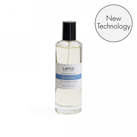 A clear LAFCO Sea & Dune Room Mist bottle with a black cap features a blue and white label showcasing essential oil-based scents. A circular graphic in the top right highlights New Technology.