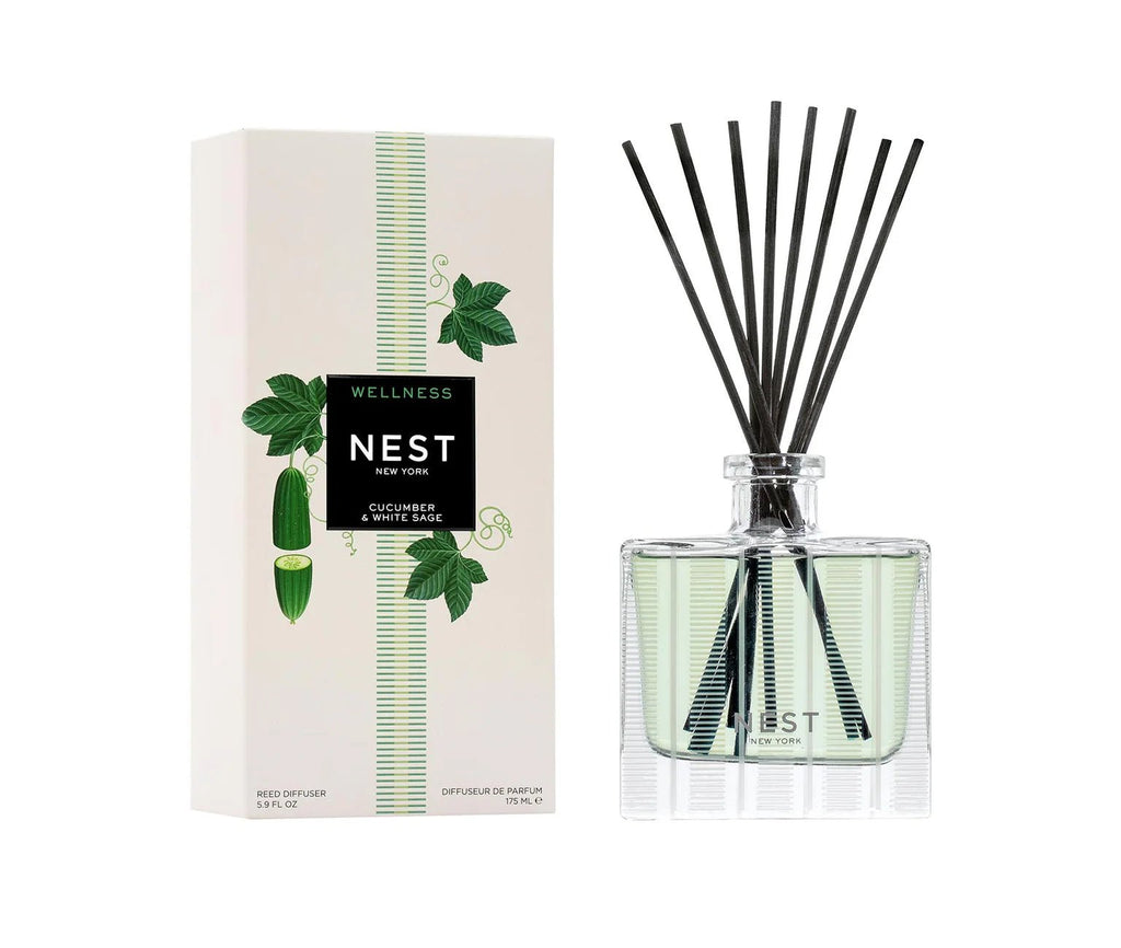 Nest - Cucumber & White Sage Reed Diffuser features green liquid with black reeds in a glass bottle. The box displays cucumber and leafy designs, highlighting this cruelty-free fragrance by Nest for your space.